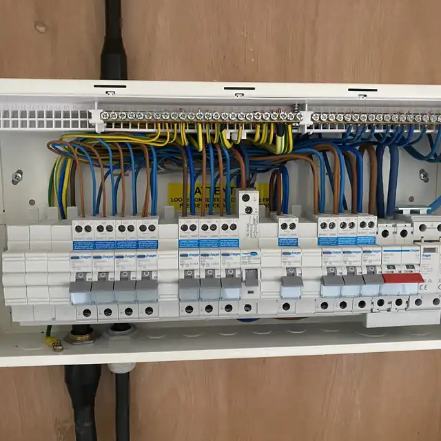 Open distribution board with a row of new breakers